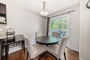 Edmonton house for rent - a dining room with a table and chairs and a large window