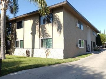 San Bernardino apartment for rent - a white house with a palm tree in front of it