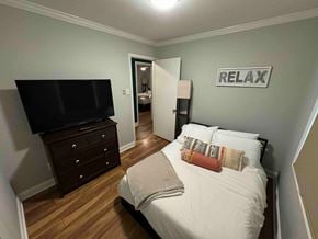 Charlotte house for rent - a bedroom with a bed and a tv