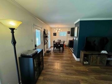 Charlotte house for rent - a living room and dining room with a tv and a table
