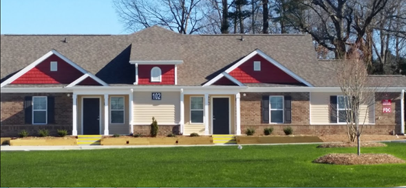 Angier apartment for rent - a home with red and white siding and a gray roof