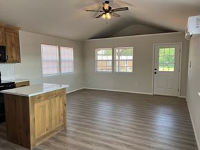 Shawnee house for rent - A kitchen with a wooden island and a ceiling fan.