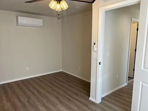 Shawnee house for rent - A room with a ceiling fan and a door.