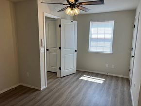 Shawnee house for rent - A room with a ceiling fan and a door.