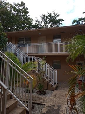 Homestead apartment for rent - an apartment building with stairs and a courtyard