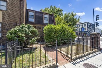 Washington apartment for rent - the front yard of a brick house behind a metal fence