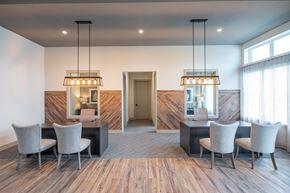 Houston apartment for rent - a dining room with a table and chairs and two chandeliers