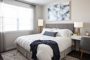 Houston apartment for rent - a bedroom with a bed and a desk with a chair