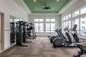 Cypress apartment for rent - a gym with cardio equipment and large windows