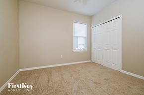 Lakeland house for rent - a bedroom with a closet and a door and a window