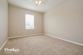 Lakeland house for rent - a spacious room with carpet and a window