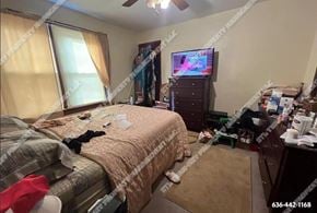 St. Louis house for rent - a bedroom with a bed and a tv in a messy room