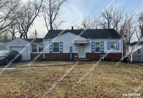 St. Louis house for rent - a white house with blue shutters and a yard