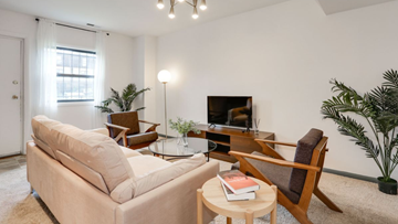 Washington apartment for rent - a living room with a couch and chairs and a television