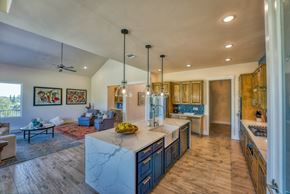 Horseshoe Bay house for rent - a kitchen with blue cabinets and a marble counter top