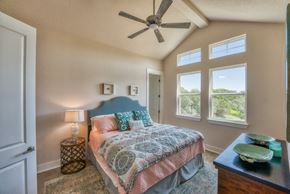 Horseshoe Bay house for rent - a bedroom with a large bed and a ceiling fan