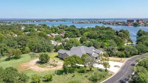 Horseshoe Bay house for rent - an aerial view of a house with a lake in the background