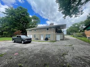 Louisville house for rent - A grey truck is parked in front of a two-story house.