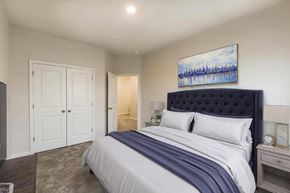 Chambersburg apartment for rent - A bedroom with a large bed and a painting on the wall.