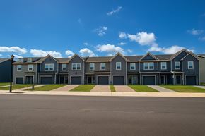 Chambersburg apartment for rent - A row of houses with grey roofs and blue walls.