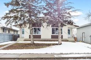 Calgary apartment for rent - front of house with trees in the front yard