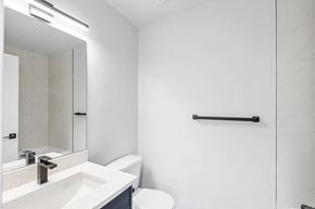 Calgary apartment for rent - a bathroom with a sink and a toilet and a mirror