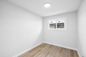 Calgary apartment for rent - a living room with white walls and a window