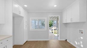 Fillmore house for rent - A white kitchen with wooden floors and a window.
