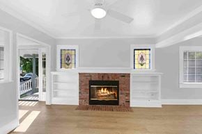 Fillmore house for rent - A living room with a fireplace and stained glass windows.