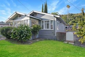 Fillmore house for rent - A grey house with a green lawn in front.
