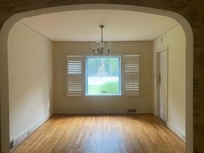 Greenwood house for rent - an empty living room with a window and a chandelier