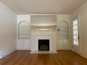 Greenwood house for rent - a living room with white walls and a fireplace and wooden floors