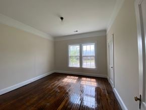 Greenwood house for rent - an empty room with wooden floors and a window