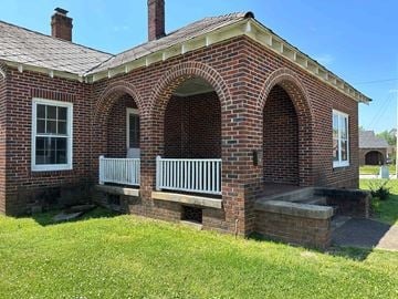 Greenwood house for rent - the front of a brick house with a porch
