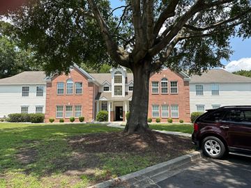 Murrells Inlet house for rent - A red brick house with a tree in front.