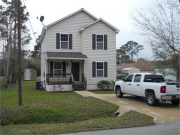St Augustine house for rent - A white house with a porch and a truck parked in front.