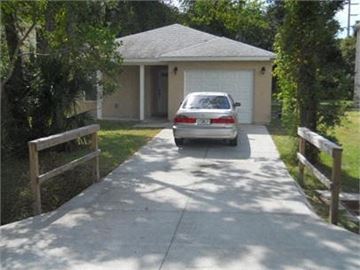 St Augustine house for rent - A car is parked in front of a garage.