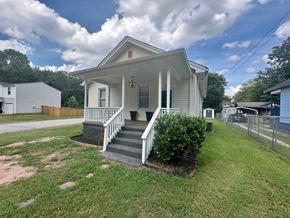 Greenville house for rent - a small white house with a front porch and a grassy yard