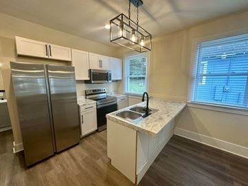 Greenville house for rent - a kitchen with a sink and a refrigerator