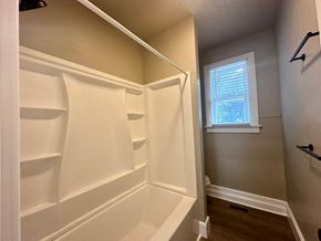 Greenville house for rent - a walk in closet with white shelves and a window