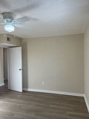 Washington apartment for rent - an empty living room with a ceiling fan and a door