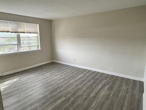 Washington apartment for rent - an empty bedroom with wood floors and a window