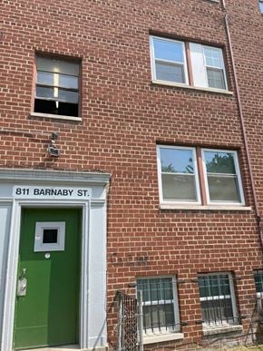 Washington apartment for rent - the side of a brick building with a green door