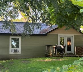 Belding house for rent - a house with a metal roof and a deck