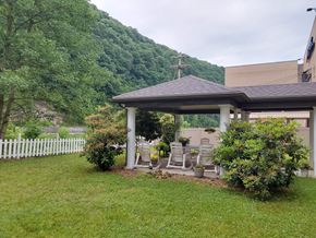 Oil City apartment for rent - a covered patio with a white fence and a house