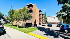 Calgary apartment for rent - A building with a yellow line on the sidewalk in front of it.