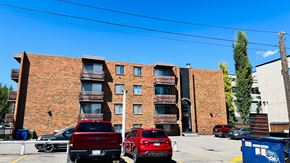 Calgary apartment for rent - A red truck is parked in front of a red car.