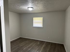 Newalla house for rent - A room with a window and wooden flooring.