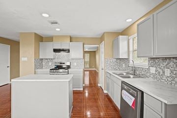 Rosenberg house for rent - an empty kitchen with white cabinets and a counter top