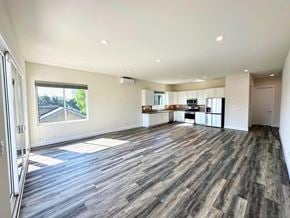 San Diego apartment for rent - A spacious room with wooden flooring and a large window.